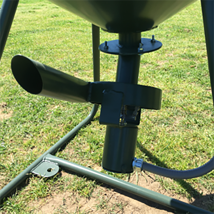 Close-up of a metal stand with cylindrical components on a grassy background