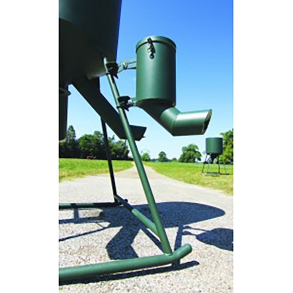 A green granular mineral feeder attached to a metal frame, set against an outdoor backdrop.