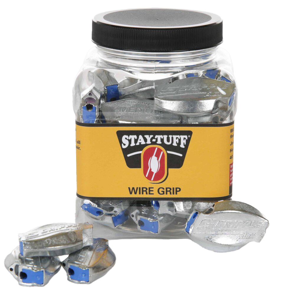 A clear plastic container with a black lid labeled 'STAY-TUFF' containing silver Wire-Grips, with some Wire-Grips scattered outside the container.