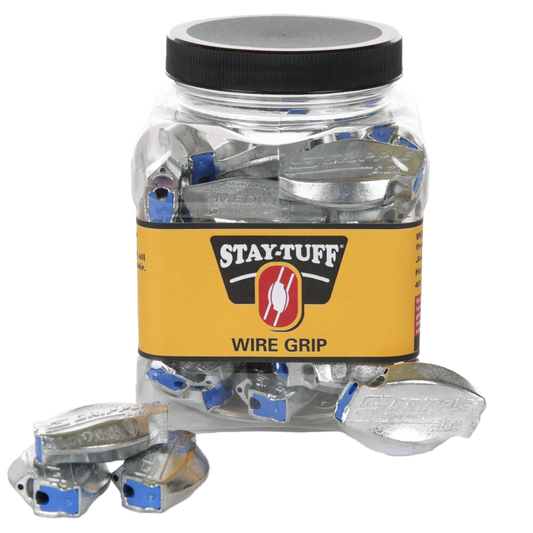 A clear plastic container with a black lid labeled 'STAY-TUFF' containing silver Wire-Grips, with some Wire-Grips scattered outside the container.